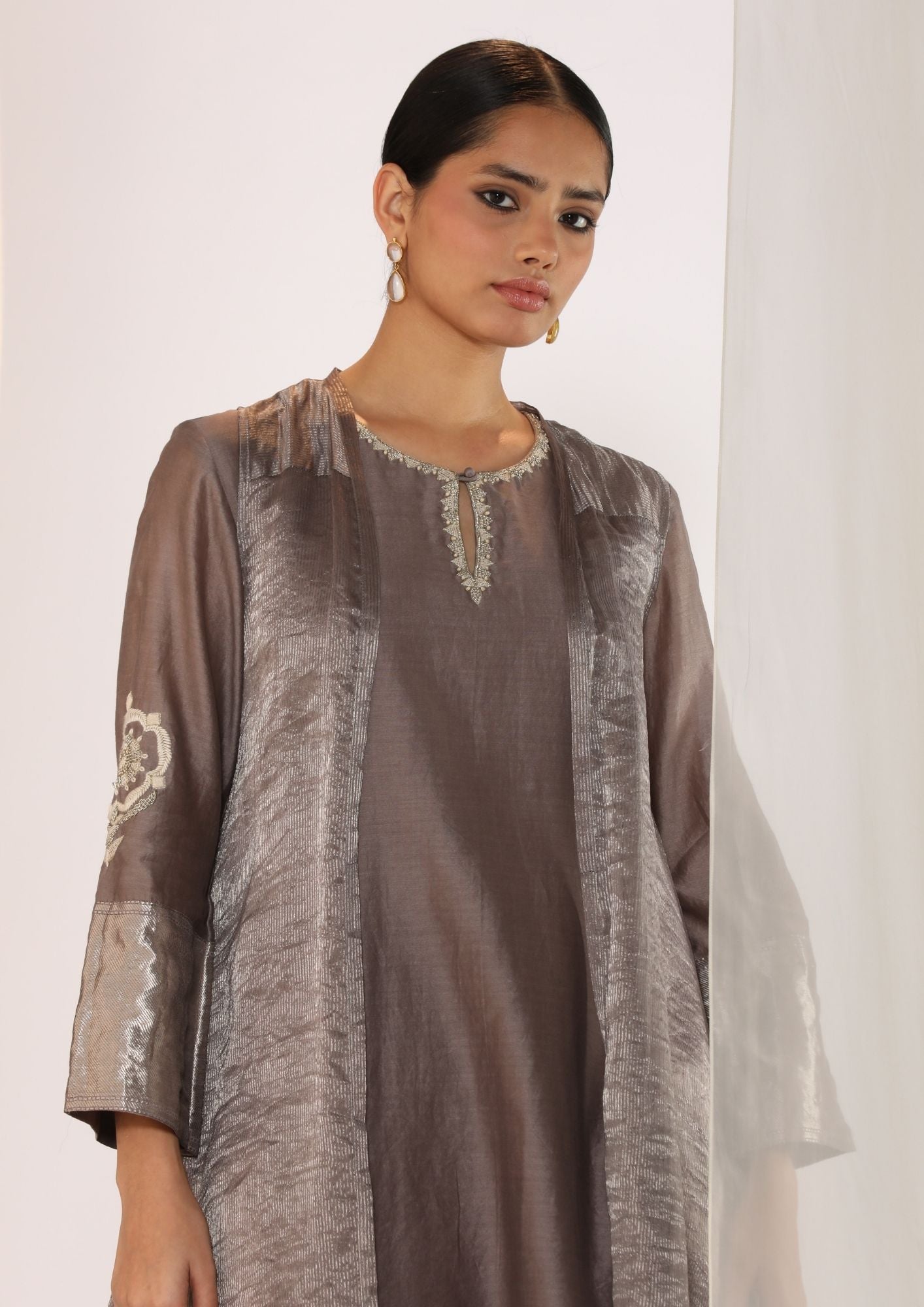 Embroidered Silk Kurta Paired With Woven Border Pants And Tissue Assymetric Cape.
