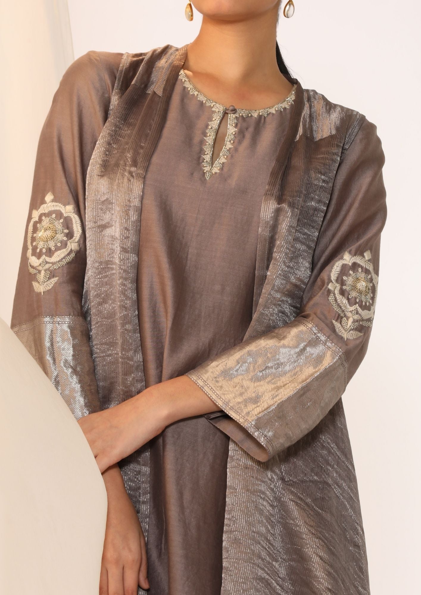Embroidered Silk Kurta Paired With Woven Border Pants And Tissue Assymetric Cape.