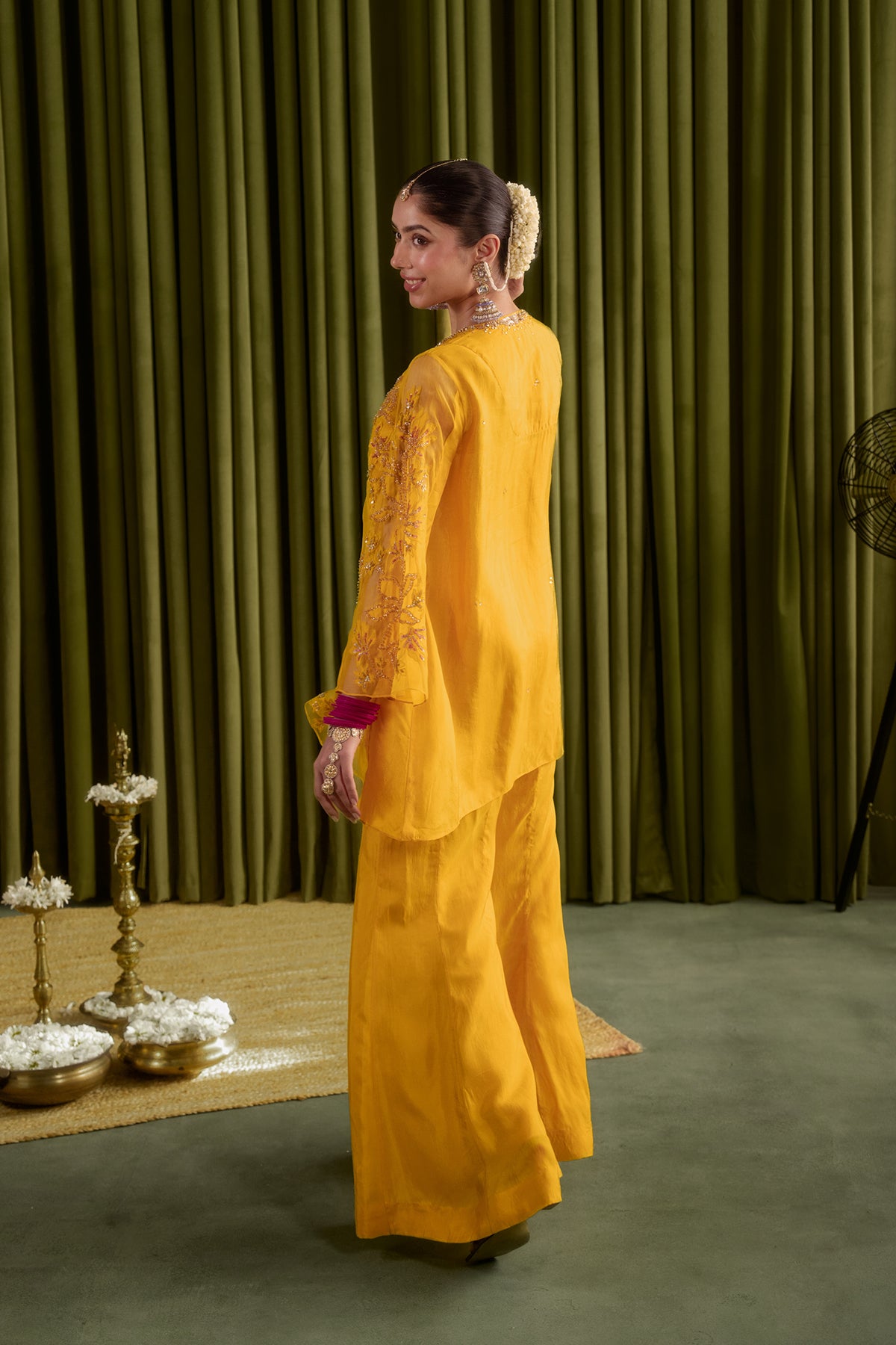 Golden yellow sharara set with embroidered magnolia flower pattern.