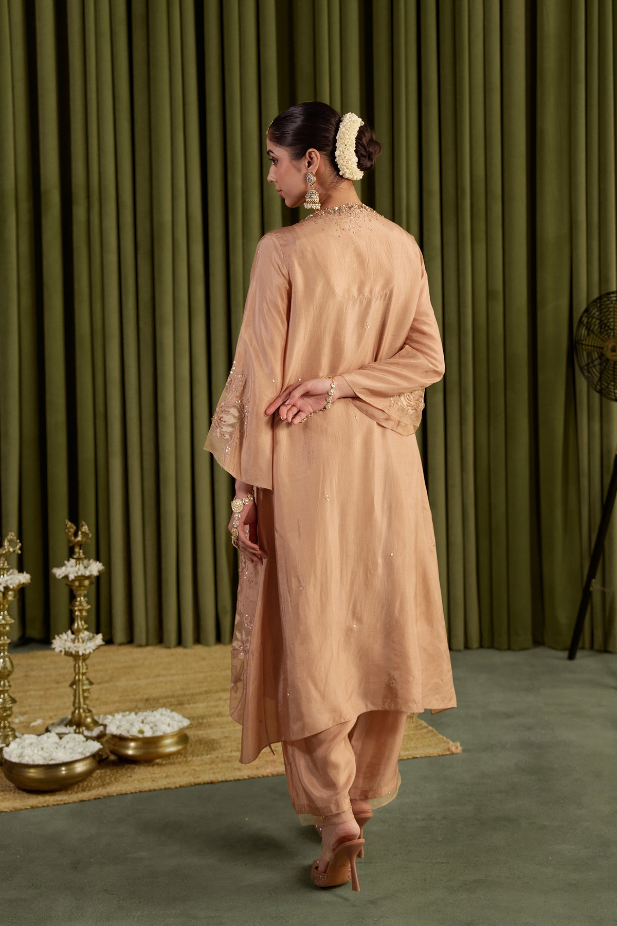 Golden beige kurta set in viscose silk base with embroidered magnolia flower pattern.
