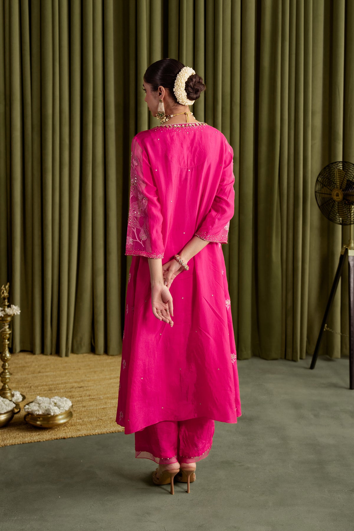Hot pink kalidar kurta set with delicate floral embroidery.