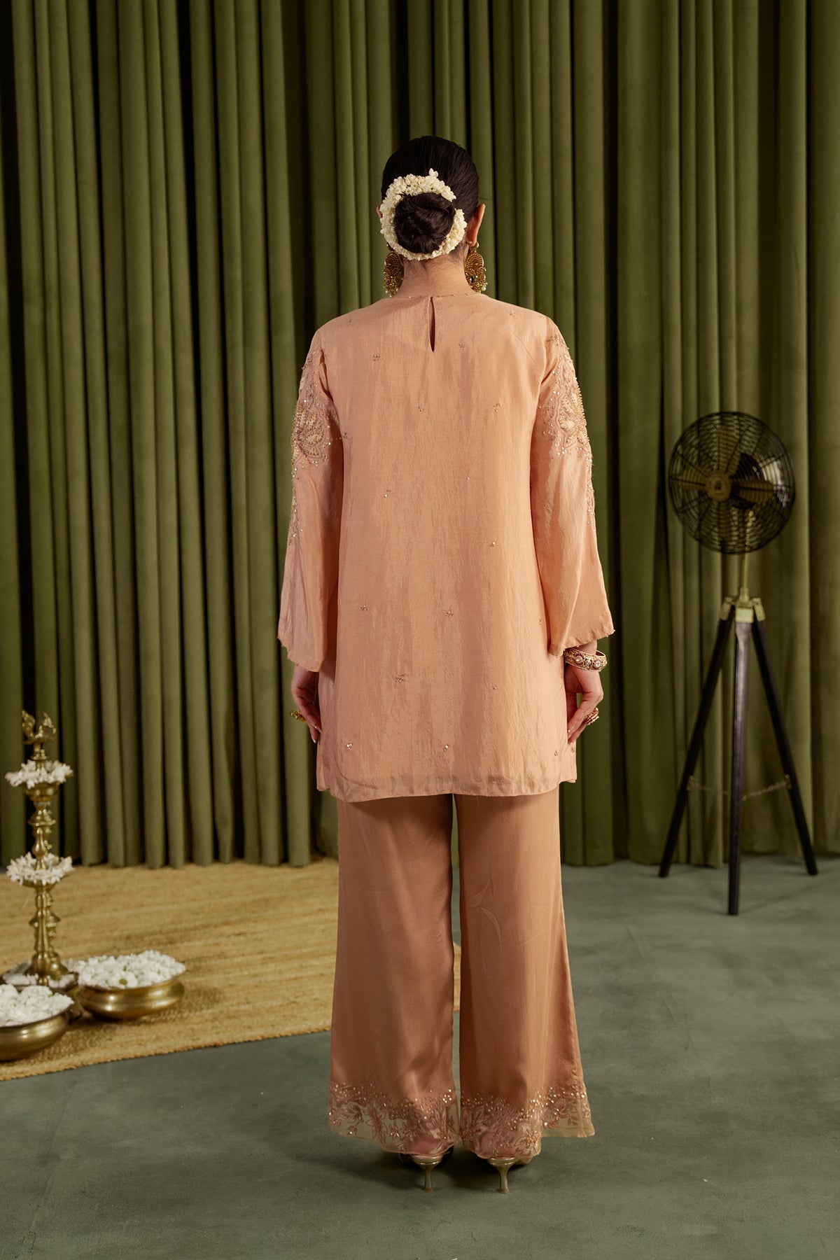 Golden beige co-ord set with embroidered magnolia flower pattern.