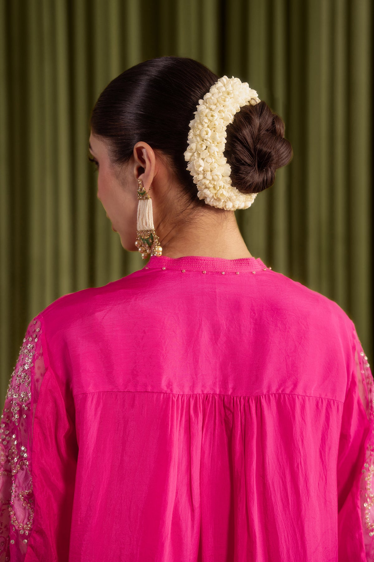 Hot pink co-ord set with embroidered floral pattern.