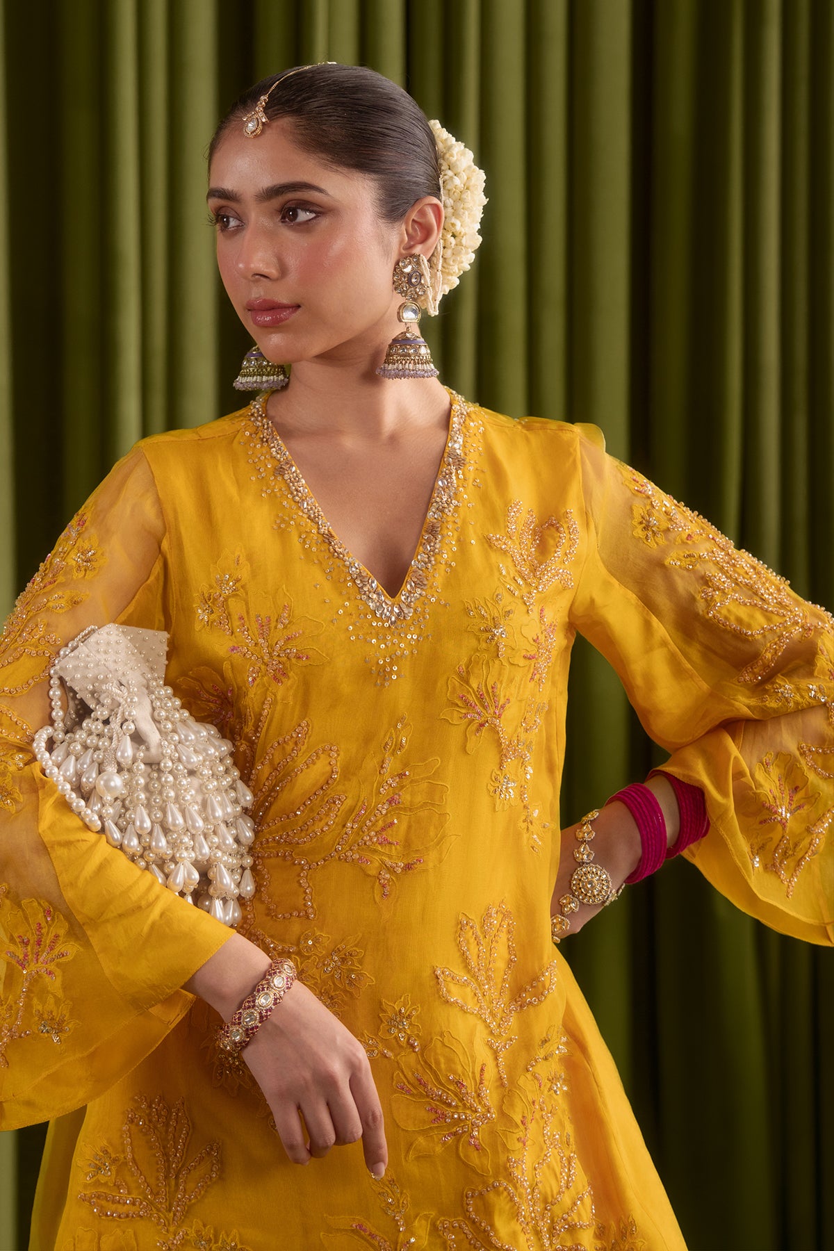 Golden yellow sharara set with embroidered magnolia flower pattern.
