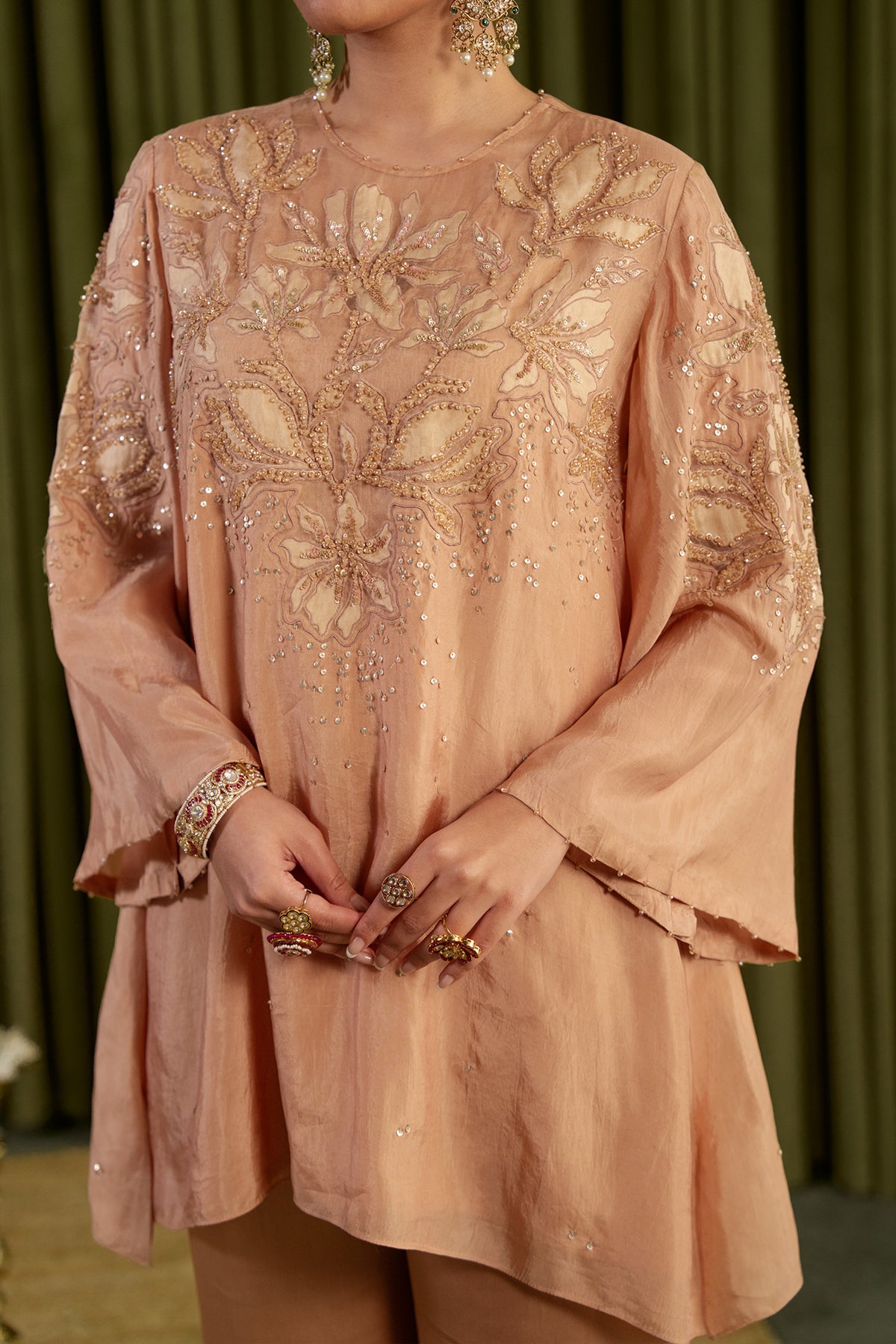 Golden beige co-ord set with embroidered magnolia flower pattern.