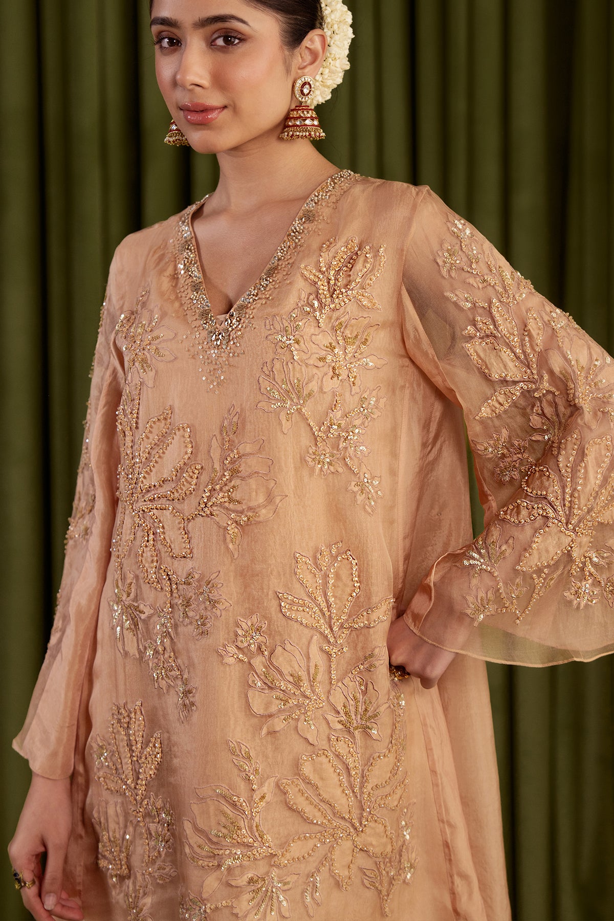 Golden beige sharara set with embroidered magnolia flower pattern.