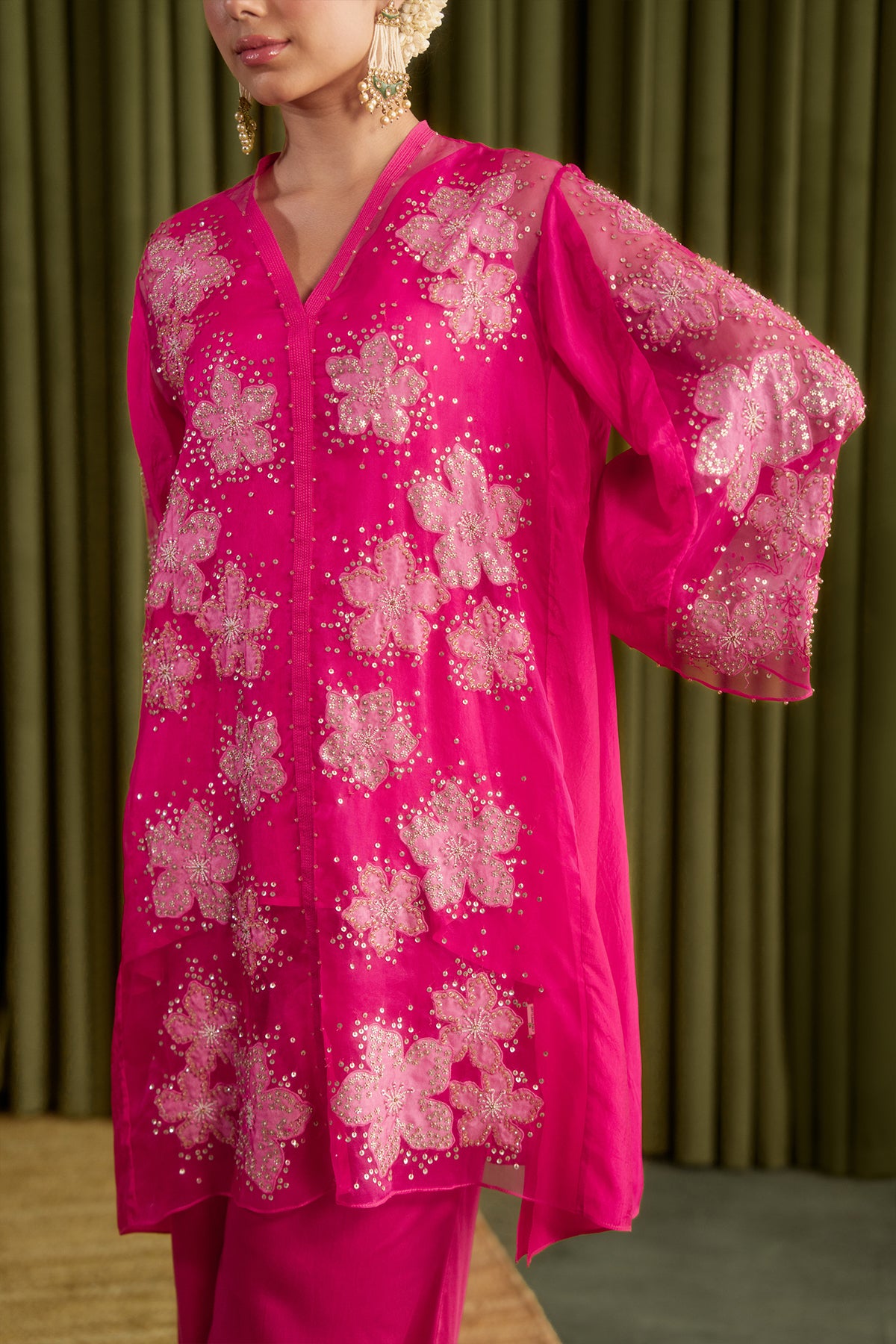 Hot pink co-ord set with embroidered floral pattern.