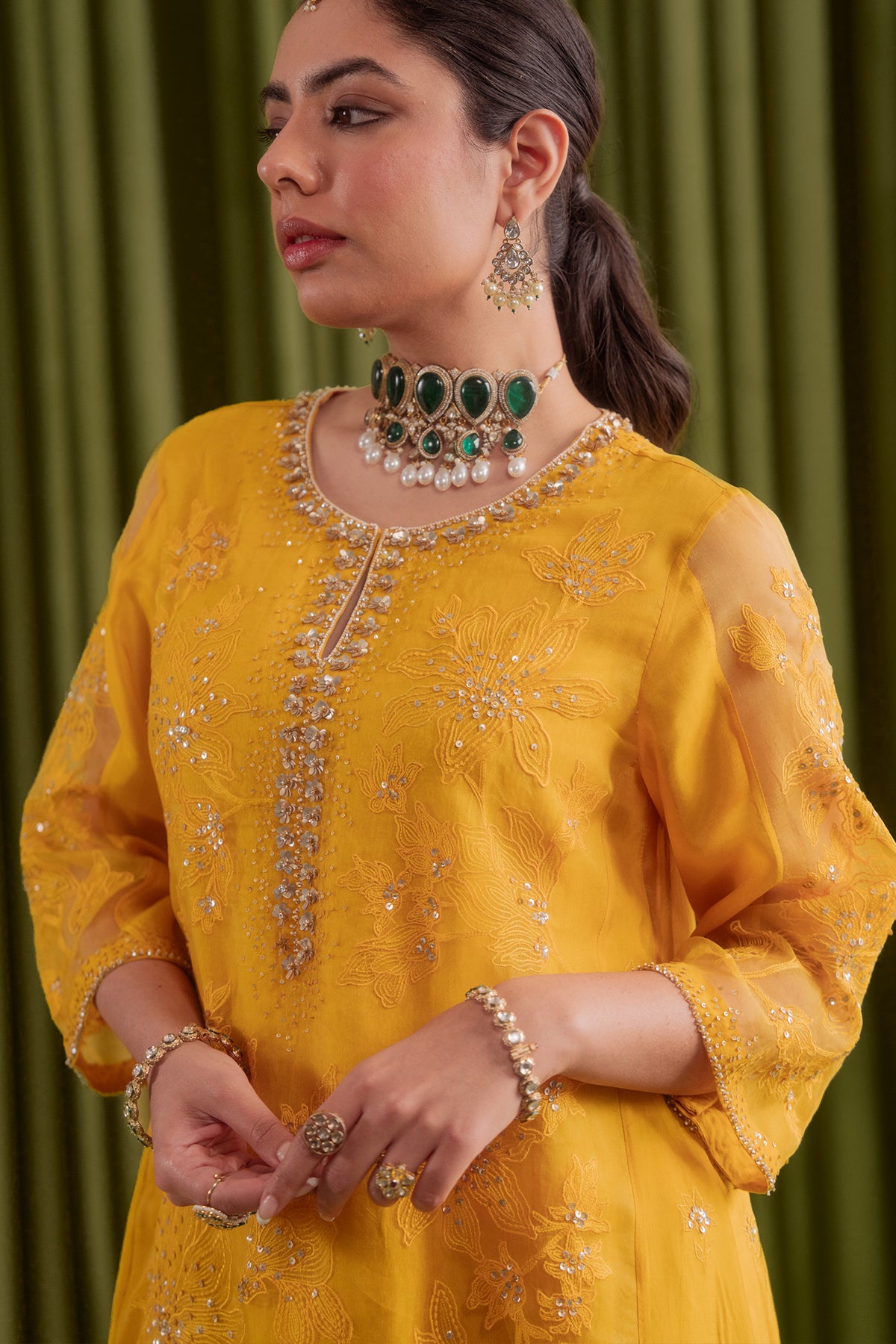 Golden yellow kalidar kurta set with delicate floral embroidery.