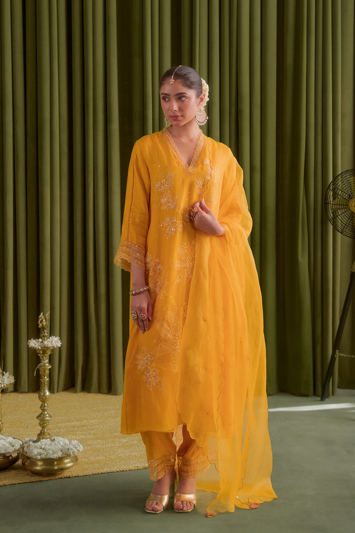 Golden yellow kurta set with delicate floral embroidery.