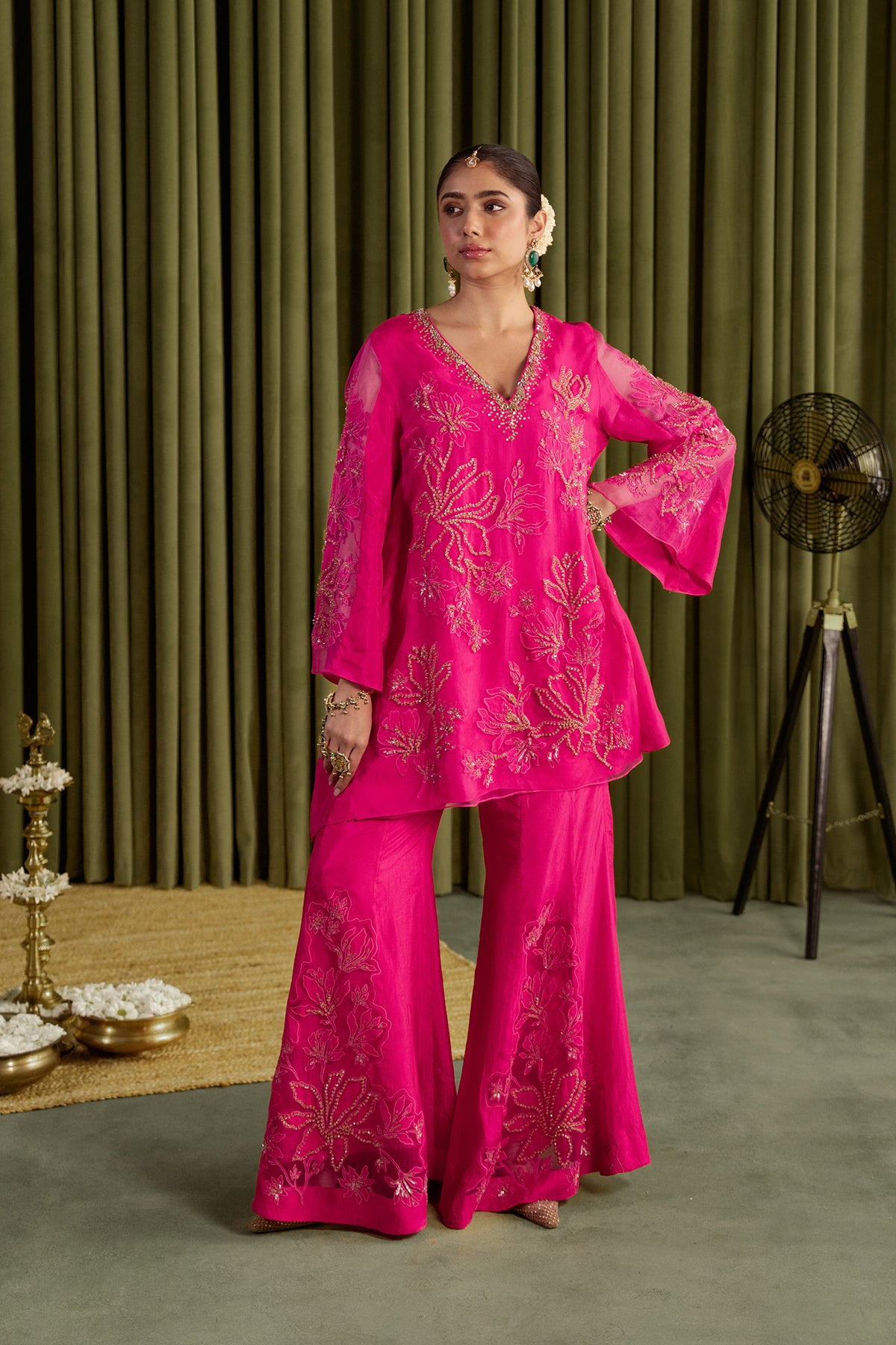 Hot pink sharara set with embroidered magnolia flower pattern.