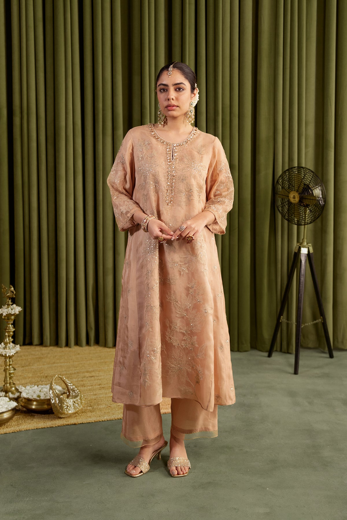 Golden beige kalidar kurta set with delicate floral embroidery.