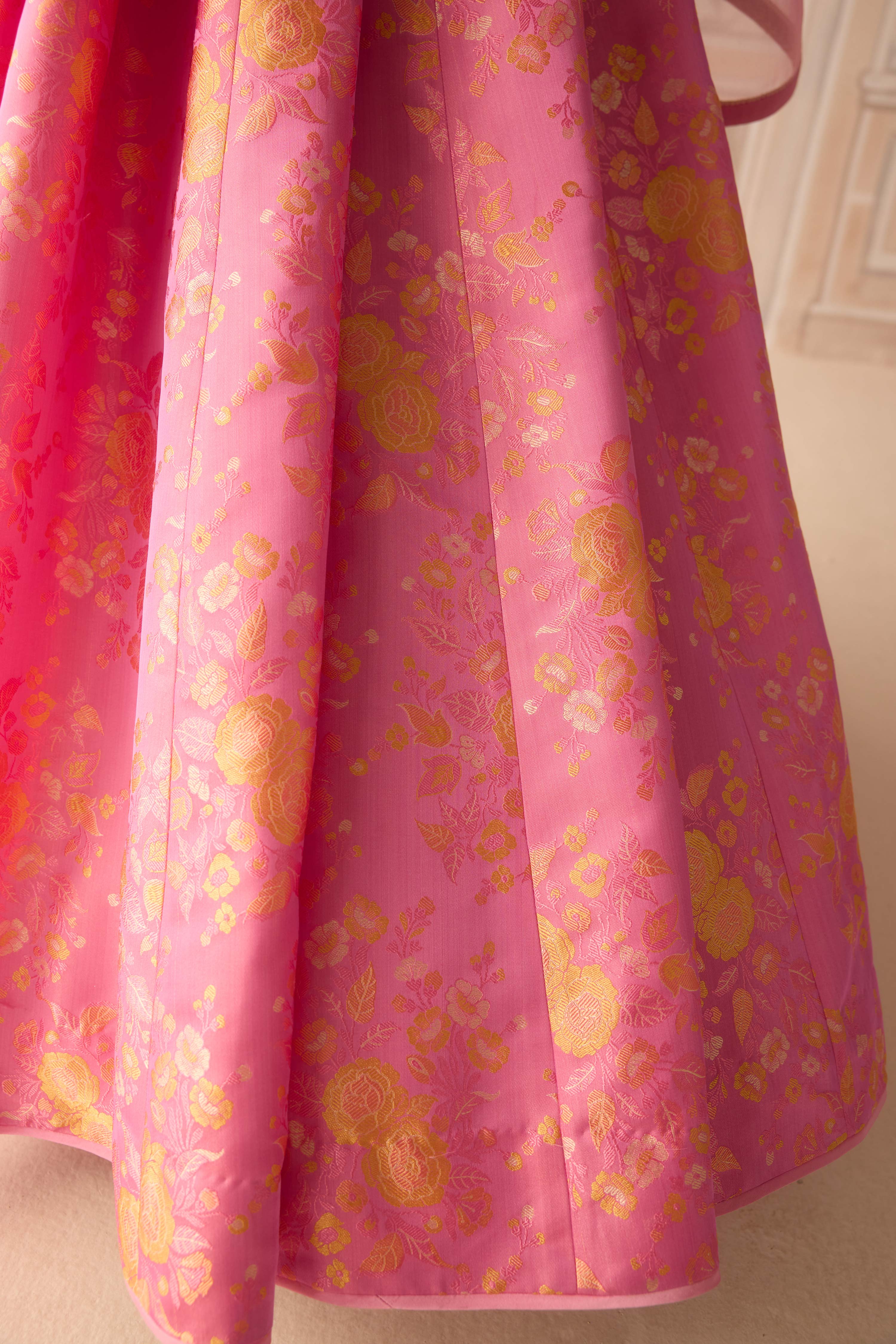 Coral pink brocade pleated lehenga with zardozi embroidered sleeveless blouse paired with organza dupatta
