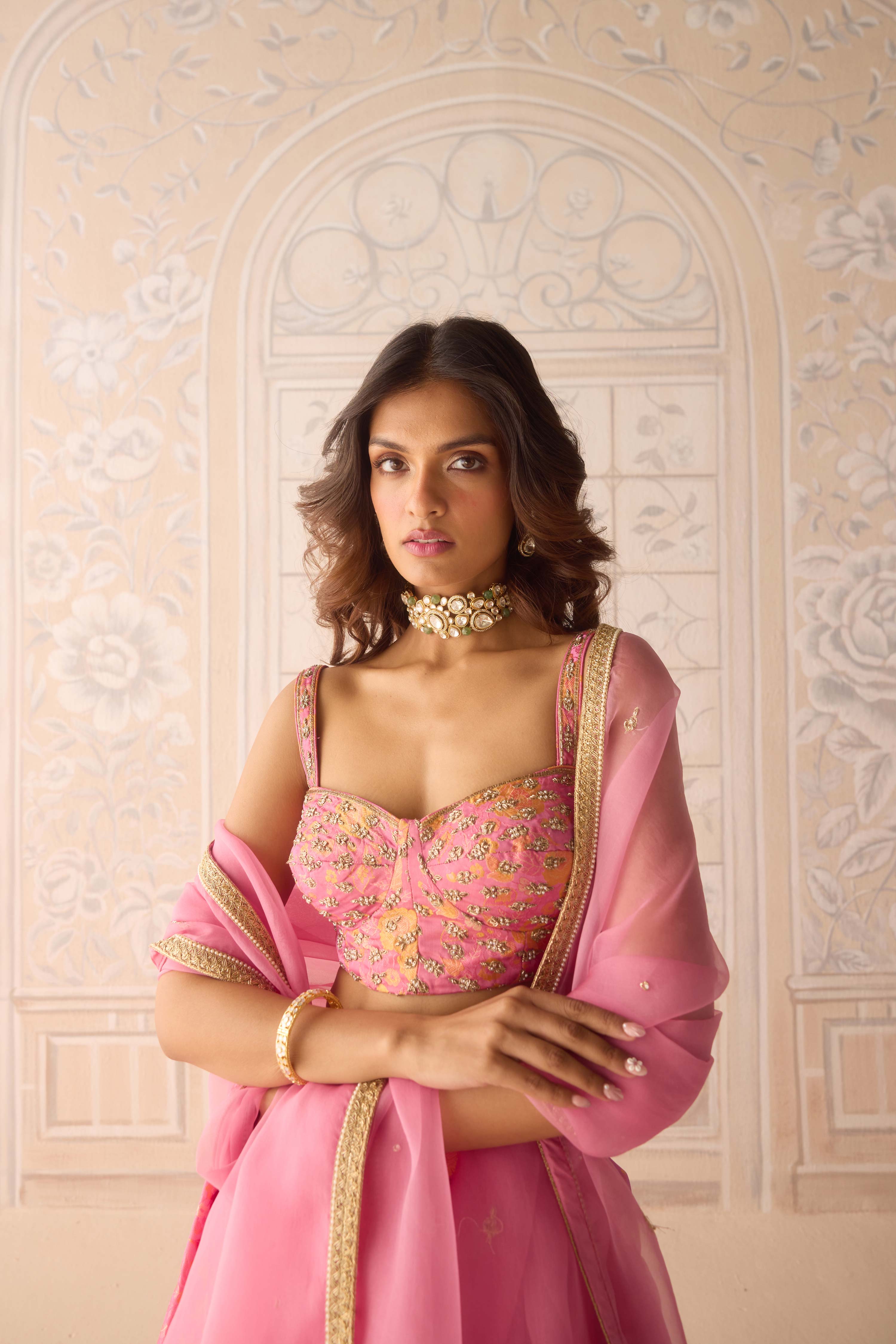 Coral pink brocade pleated lehenga with zardozi embroidered sleeveless blouse paired with organza dupatta