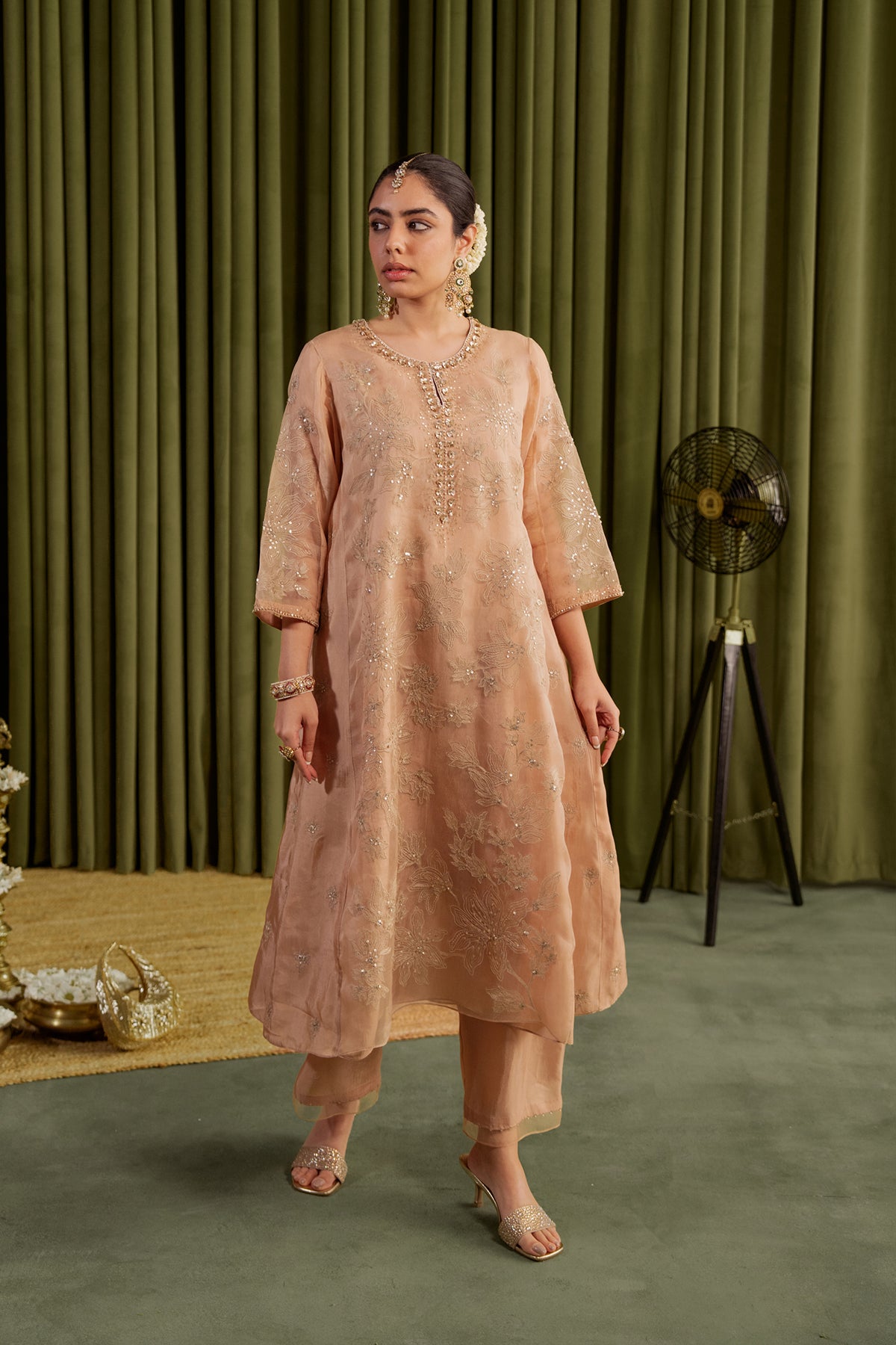 Golden beige kalidar kurta set with delicate floral embroidery.