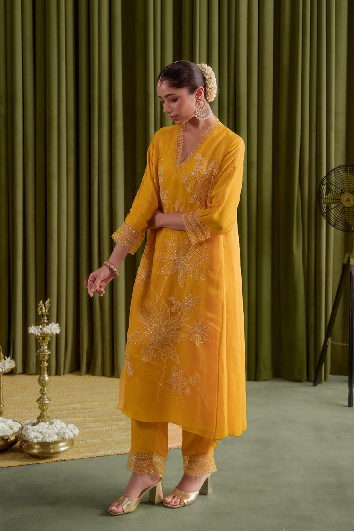 Golden yellow kurta set with delicate floral embroidery.