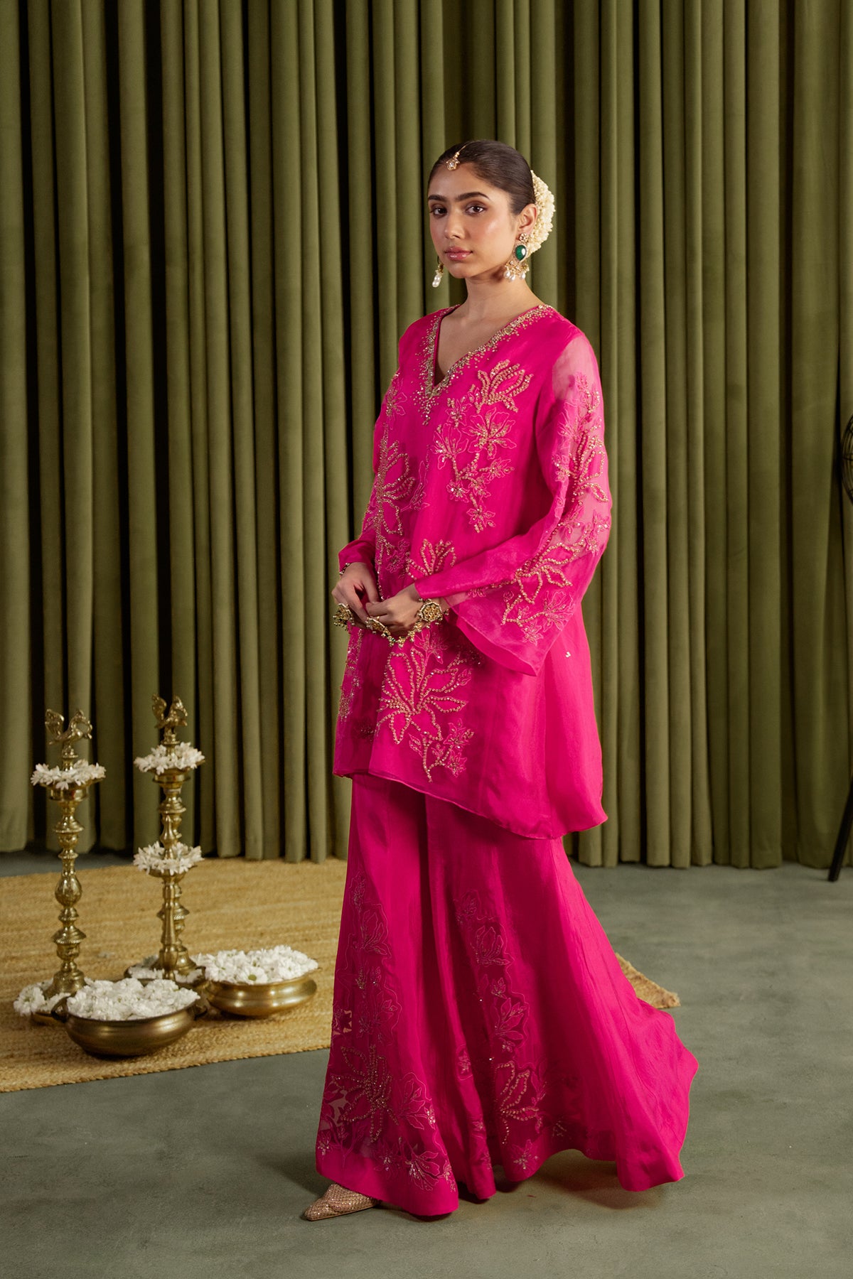 Hot pink sharara set with embroidered magnolia flower pattern.