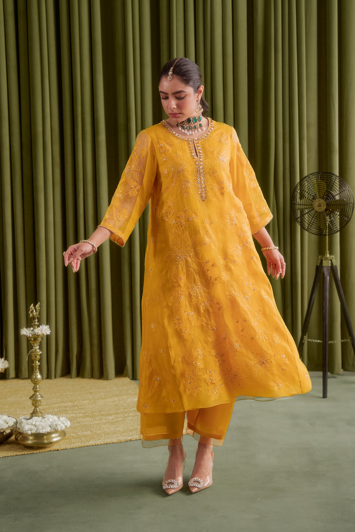 Golden yellow kalidar kurta set with delicate floral embroidery.