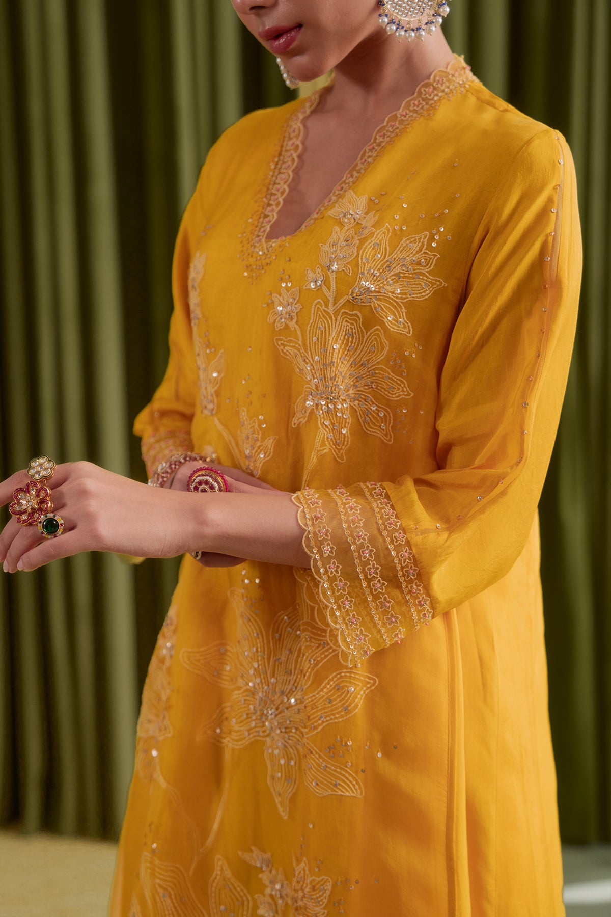 Golden yellow kurta set with delicate floral embroidery.