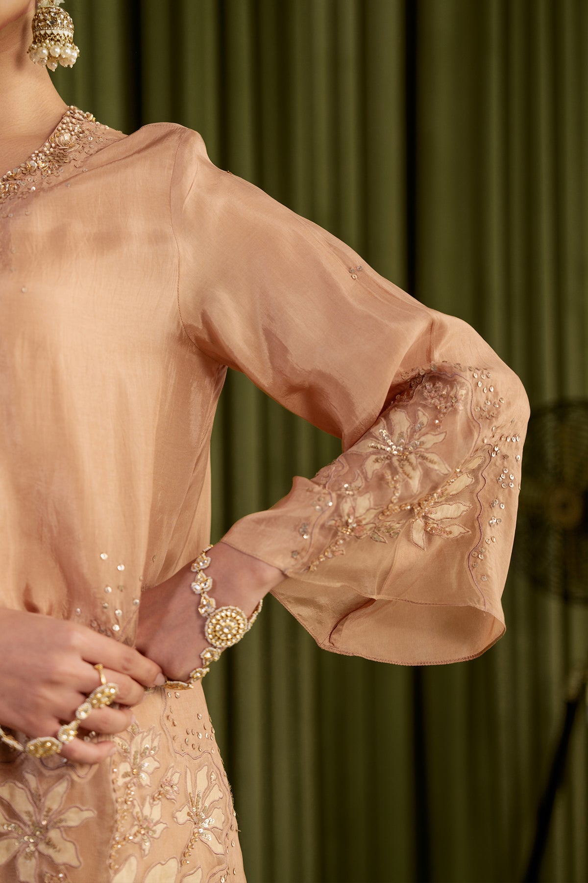 Golden beige kurta set in viscose silk base with embroidered magnolia flower pattern.