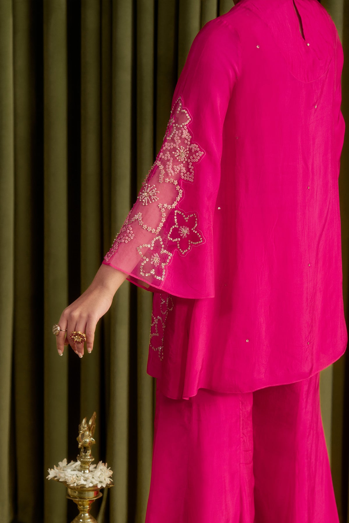 Hot pink sharara set with hand embroidered floral pattern.