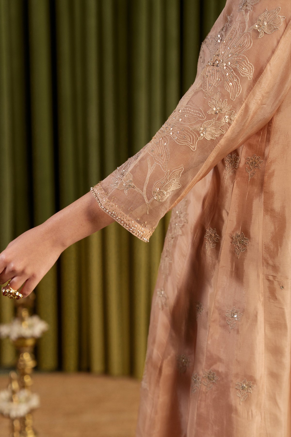 Golden beige kalidar kurta set with delicate floral embroidery.