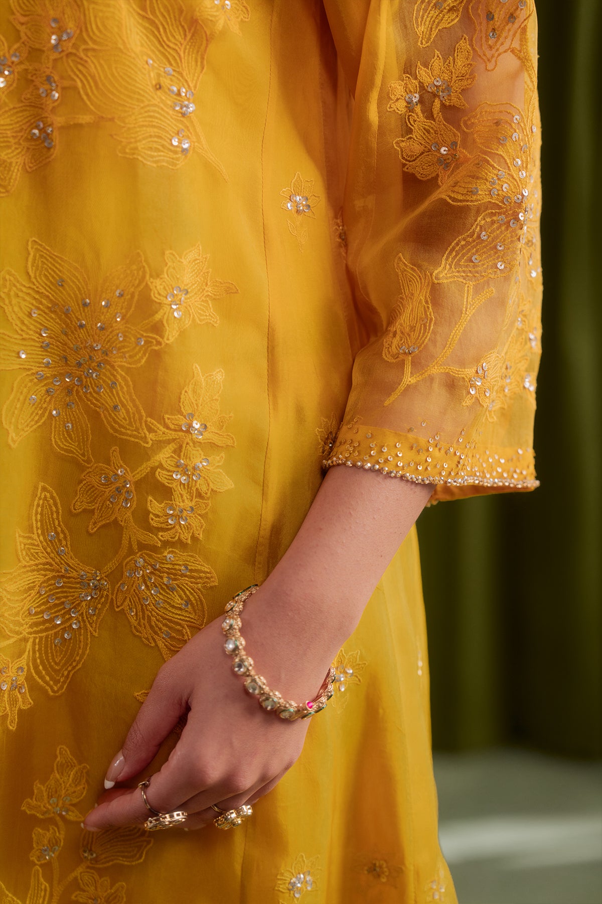 Golden yellow kalidar kurta set with delicate floral embroidery.