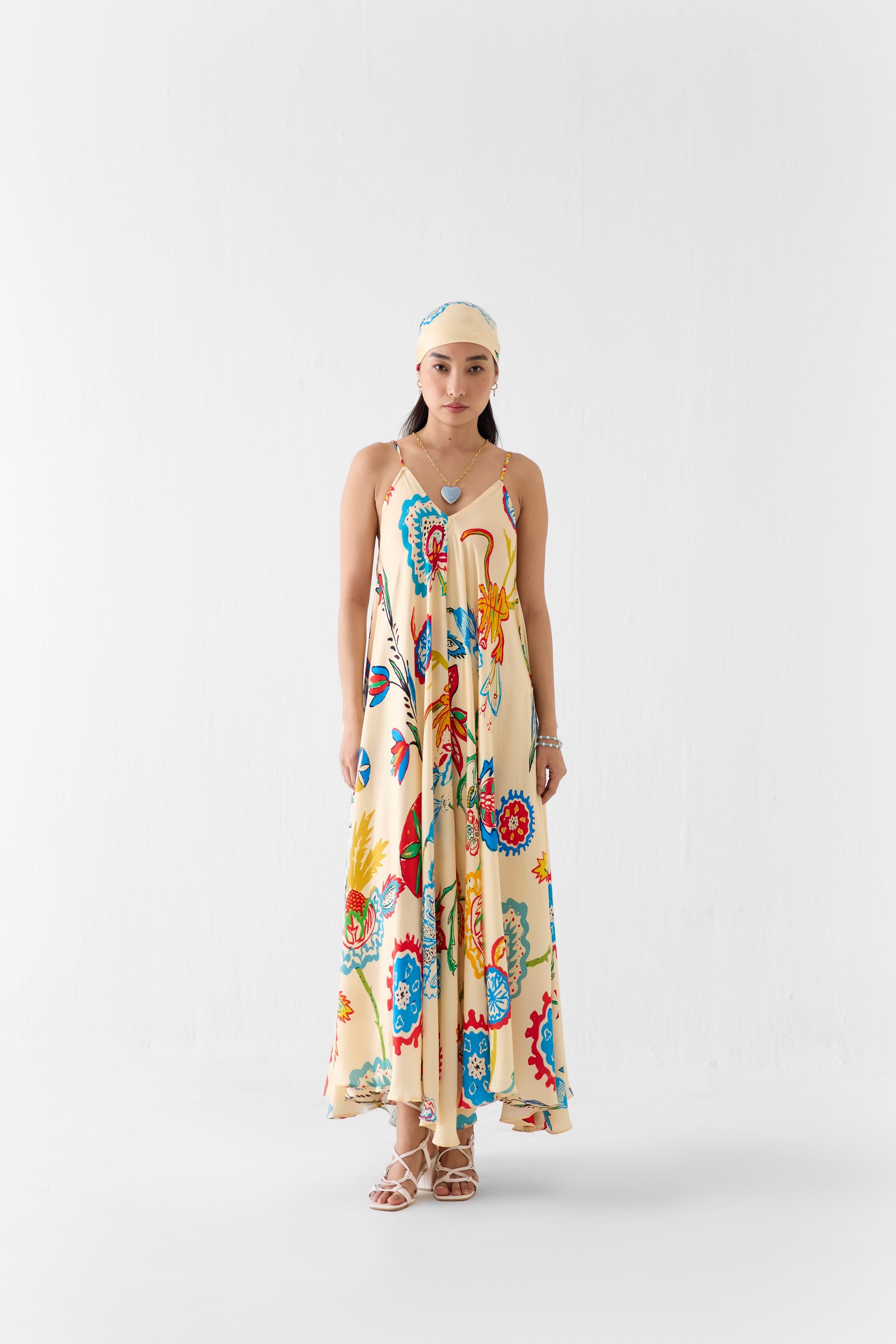 Woman wearing a colorful floral dress on a white background