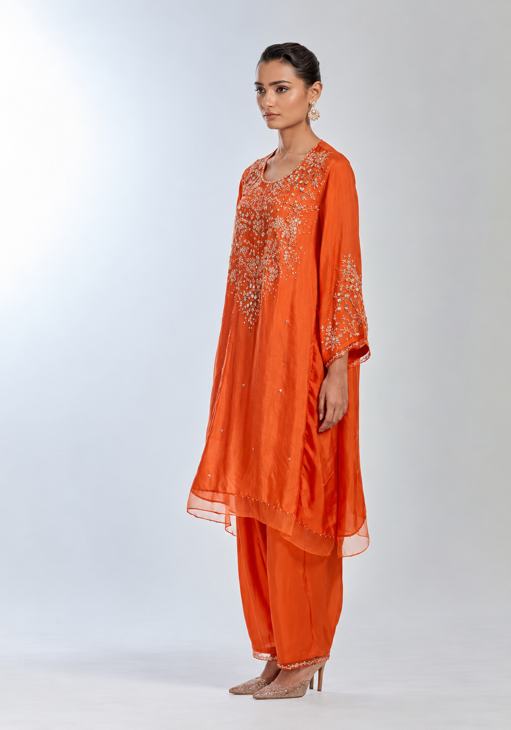 Poppy color silk salwar set with intricate sequins and crystal embroidery on yoke and sleeves