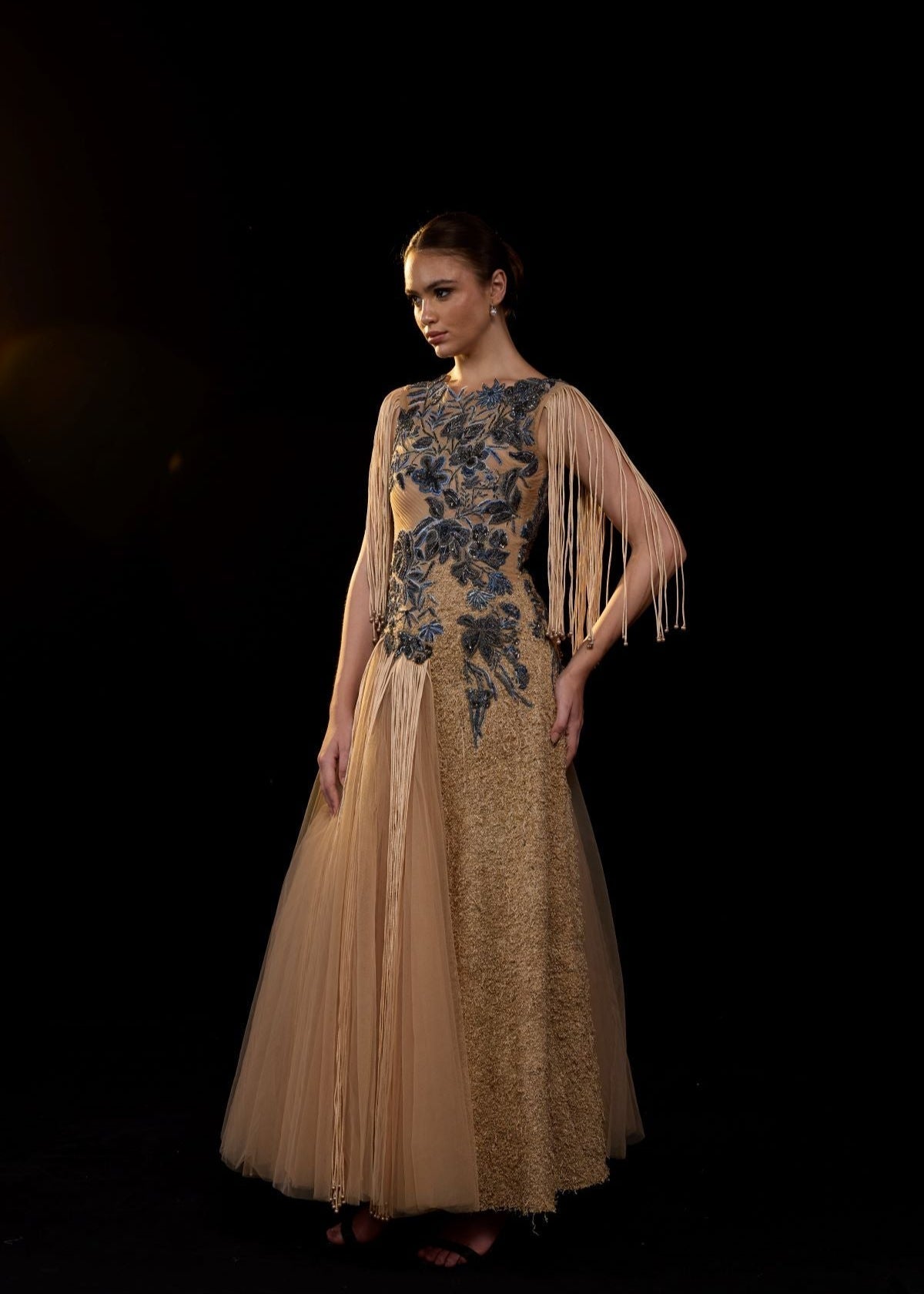 https://cdn.shopify.com/s/files/1/0088/3441/6706/files/a-nude-toned-gown-adorned-with-intricate-blue-floral-embroidery-and-dramatic-fringe-sleeves-5275036.jpg?v=1752926529