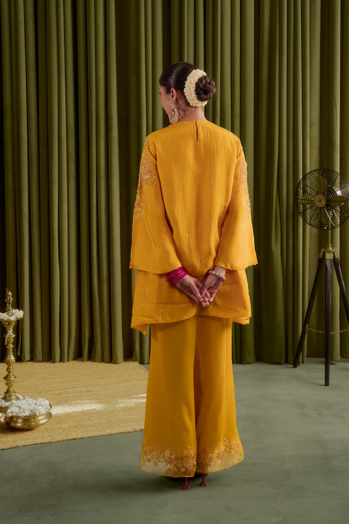 Golden yellow co-ord set with embroidered magnolia flower pattern.