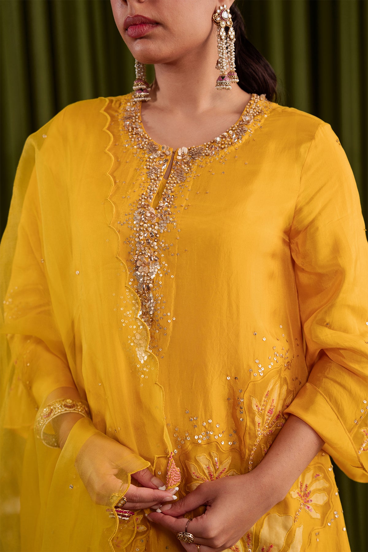 Golden yellow kurta set in viscose silk base with embroidered magnolia flower pattern.
