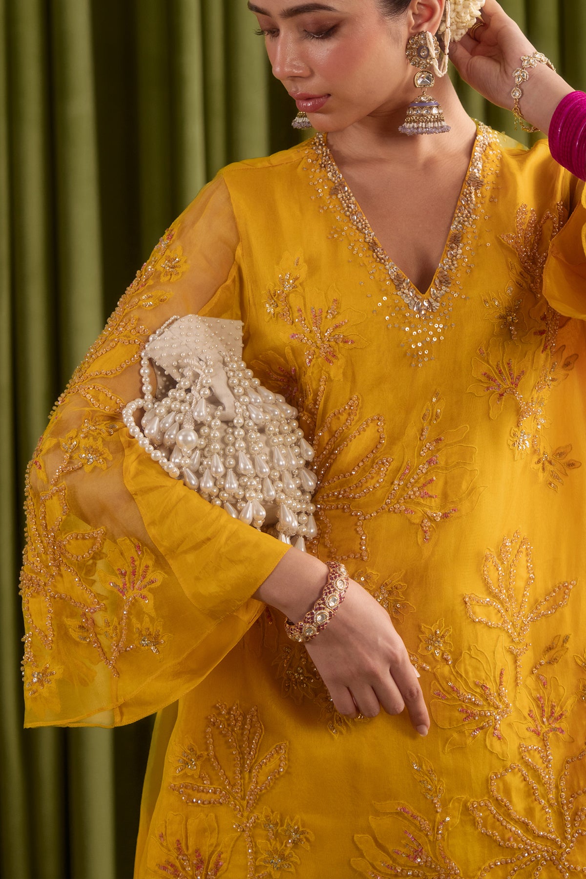 Golden yellow sharara set with embroidered magnolia flower pattern.
