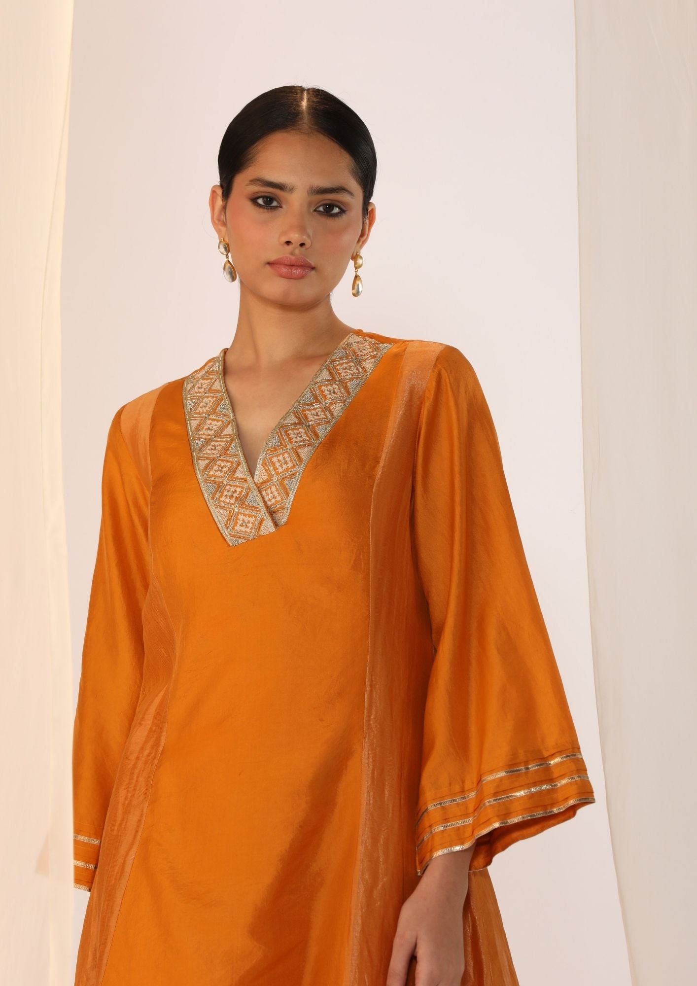Double-layer kurta with  handwork  on neckline paired with pants