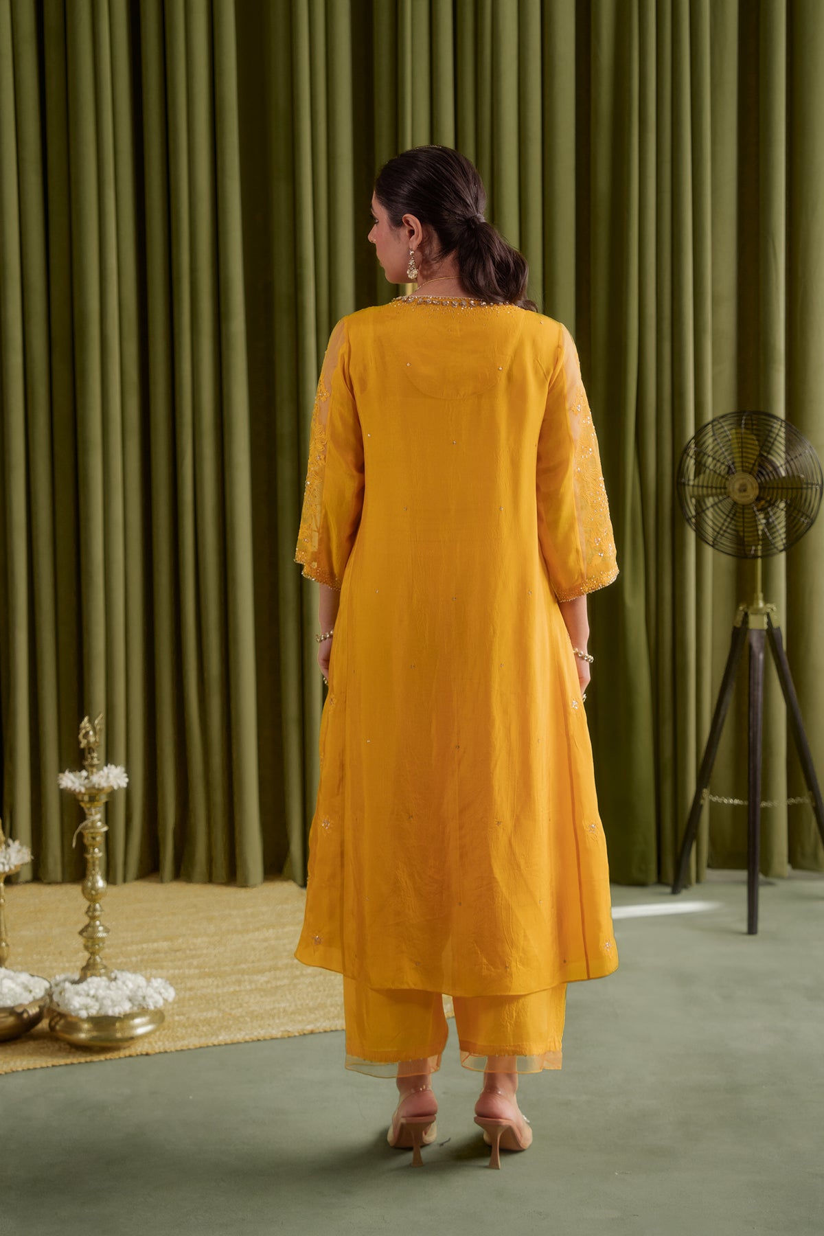 Golden yellow kalidar kurta set with delicate floral embroidery.