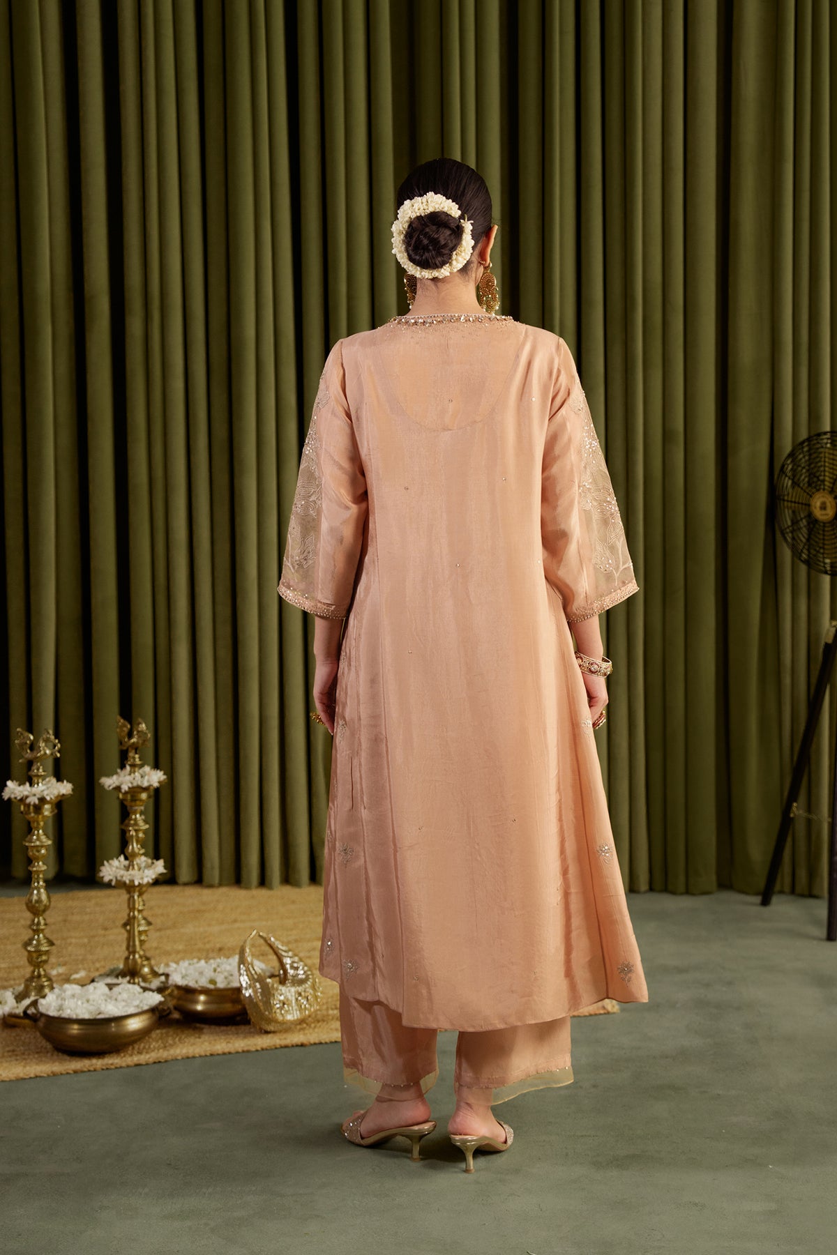 Golden beige kalidar kurta set with delicate floral embroidery.