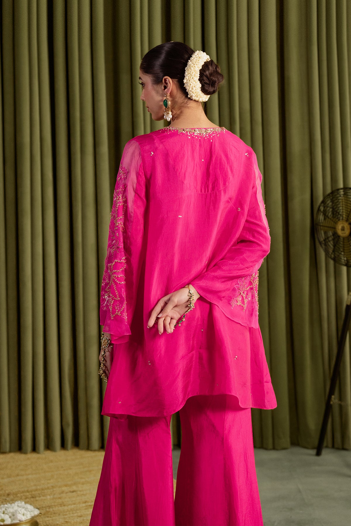 Hot pink sharara set with embroidered magnolia flower pattern.