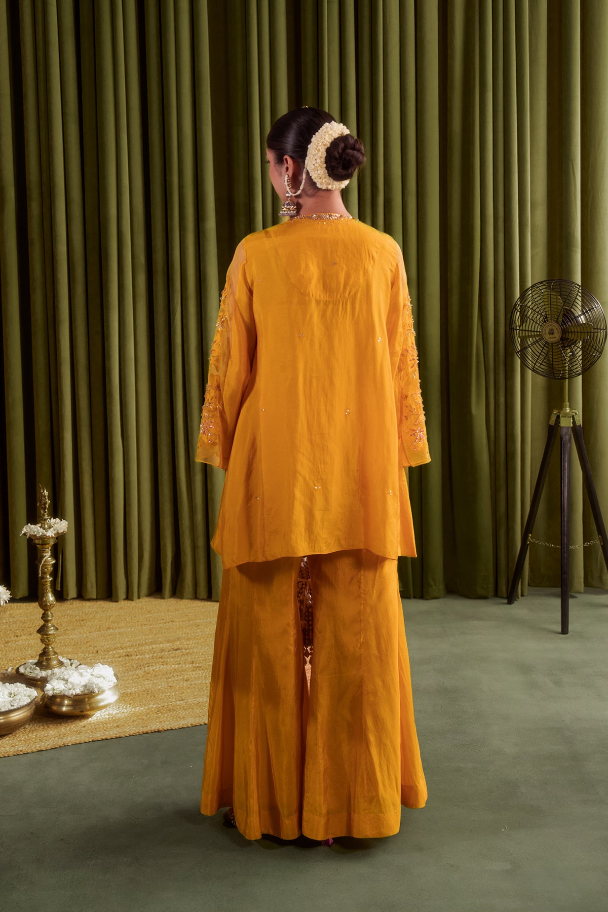 Golden yellow sharara set with embroidered magnolia flower pattern.