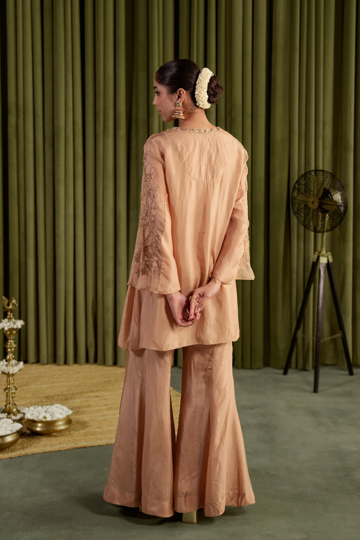 Golden beige sharara set with embroidered magnolia flower pattern.