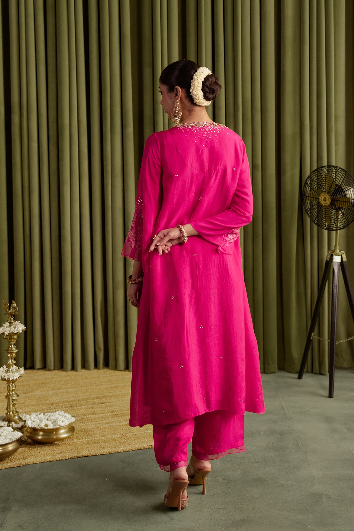 Hot pink kurta set in viscose silk base with embroidered magnolia flower pattern.