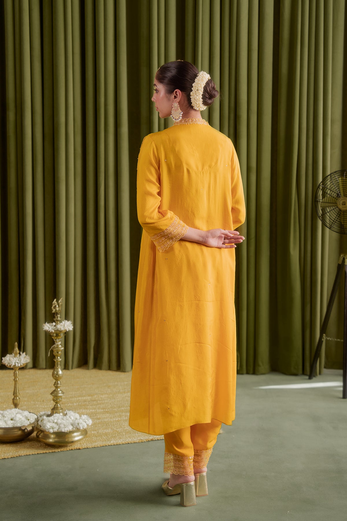 Golden yellow kurta set with delicate floral embroidery.