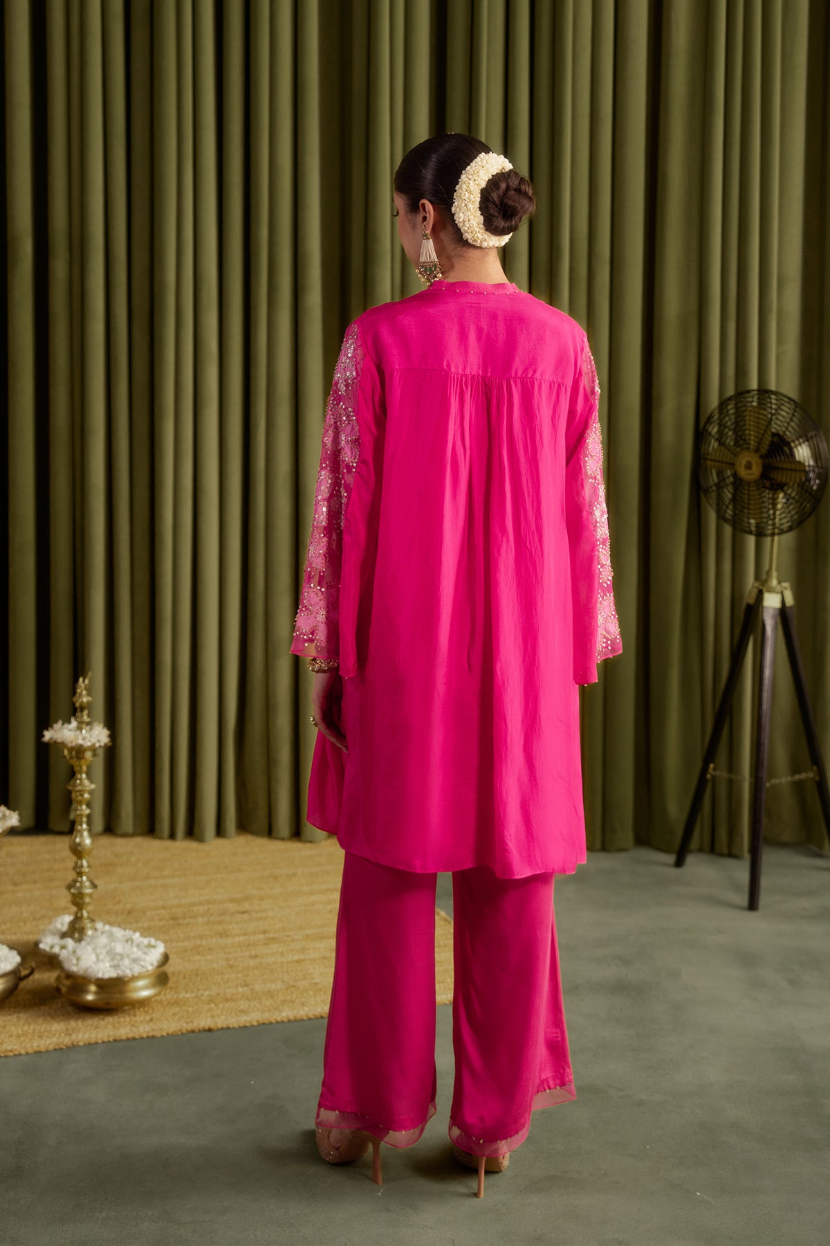 Hot pink co-ord set with embroidered floral pattern.