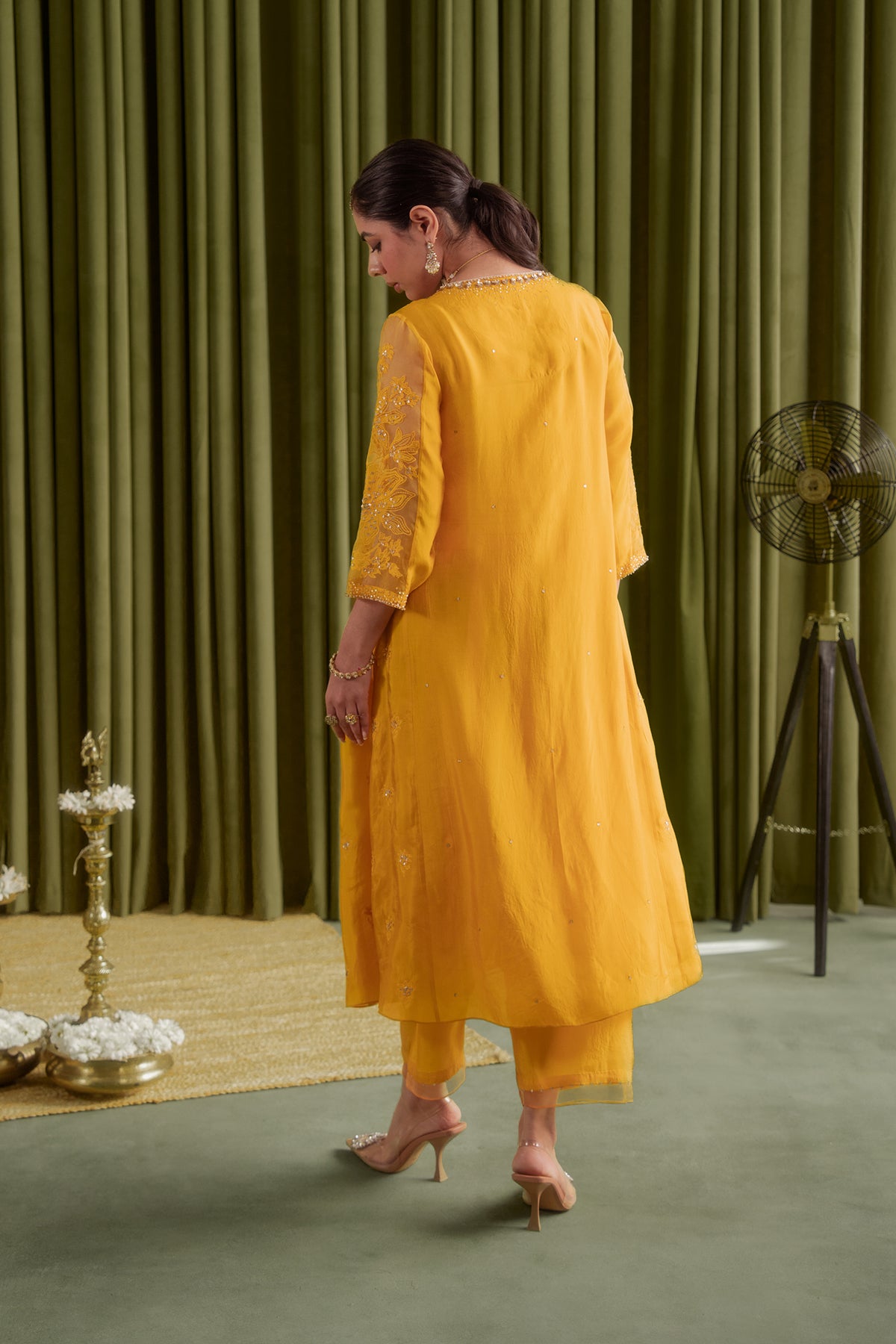 Golden yellow kalidar kurta set with delicate floral embroidery.