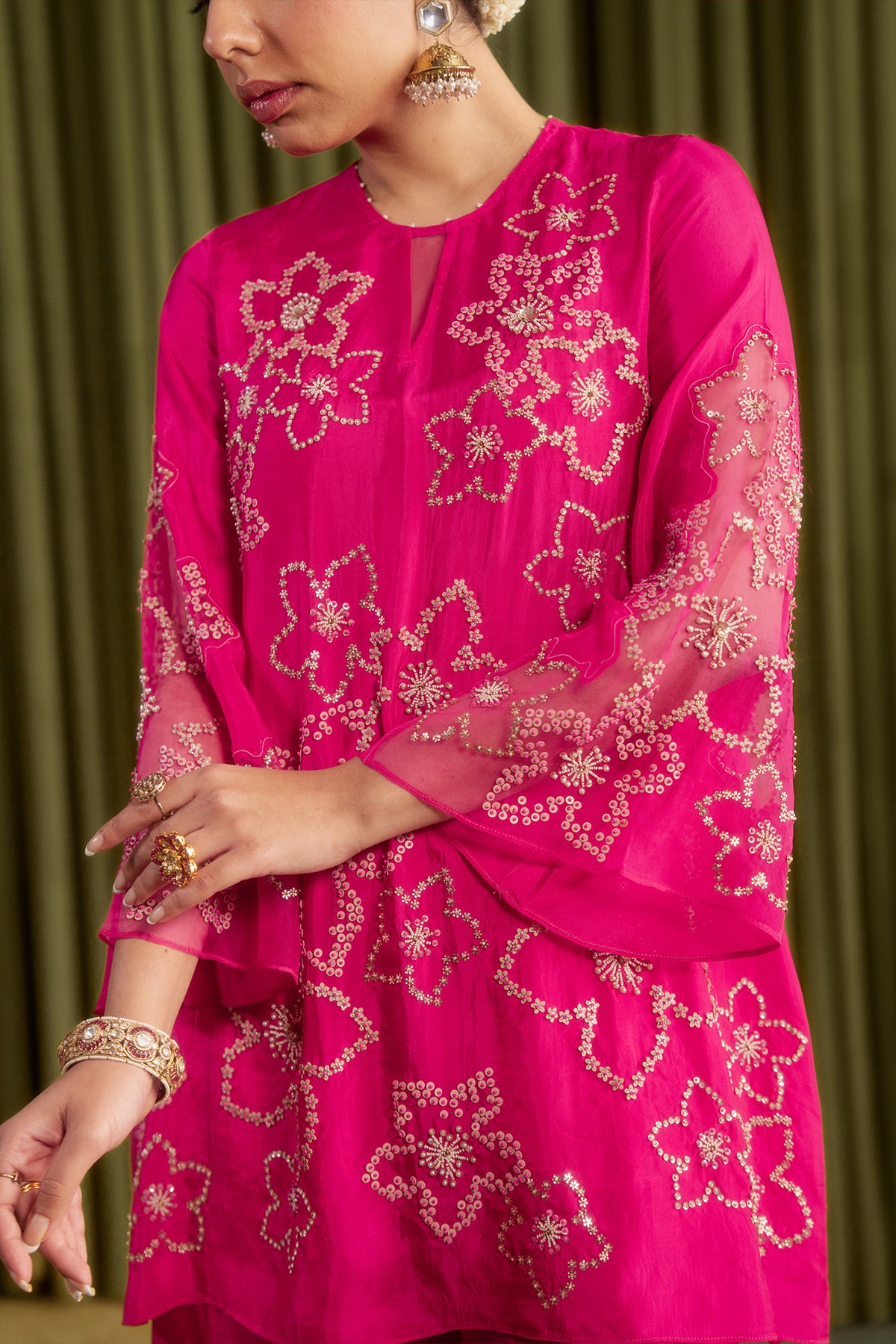 Hot pink sharara set with hand embroidered floral pattern.