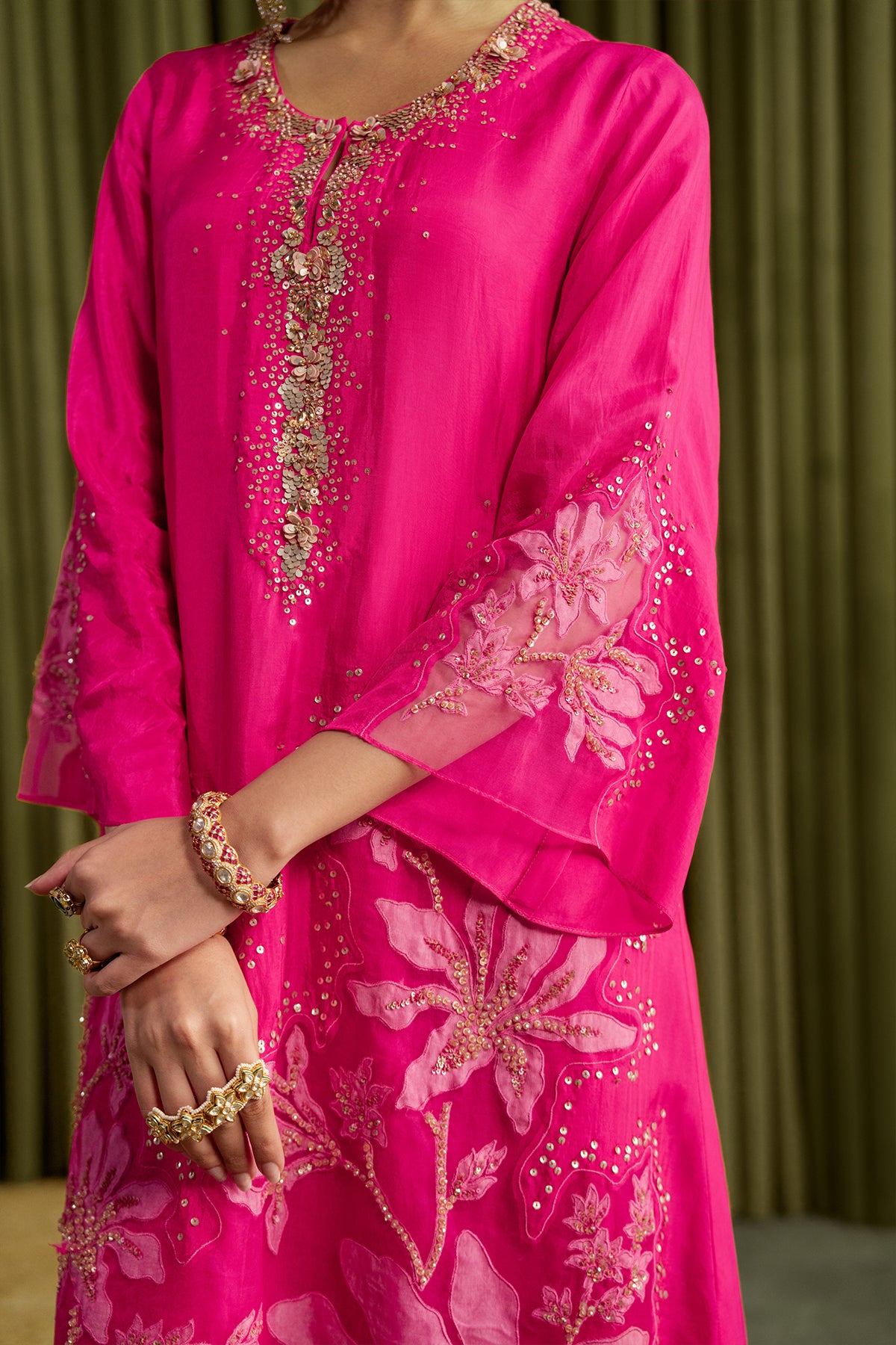 Hot pink kurta set in viscose silk base with embroidered magnolia flower pattern.