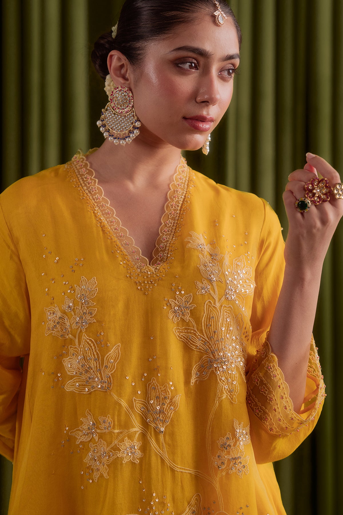 Golden yellow kurta set with delicate floral embroidery.