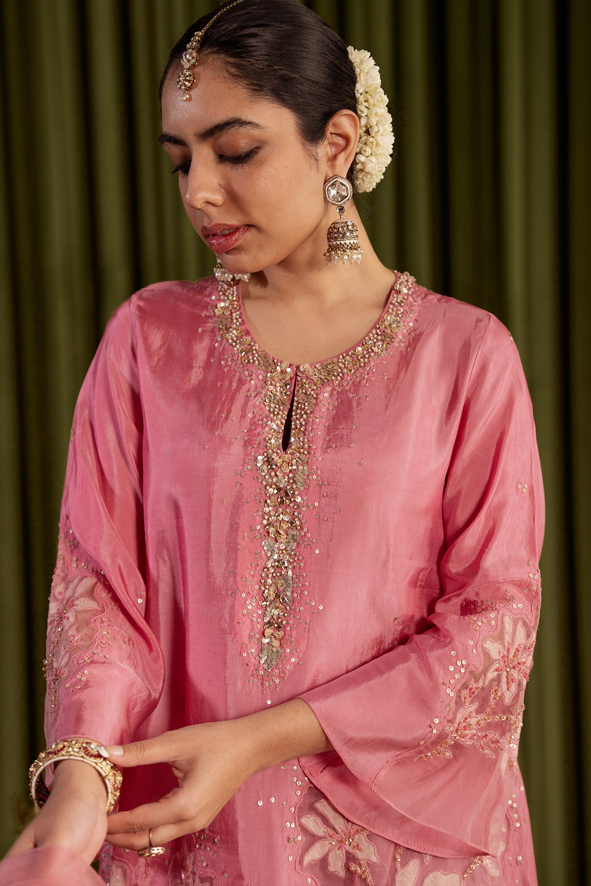 Rose pink kurta set in viscose silk base with embroidered magnolia flower pattern.