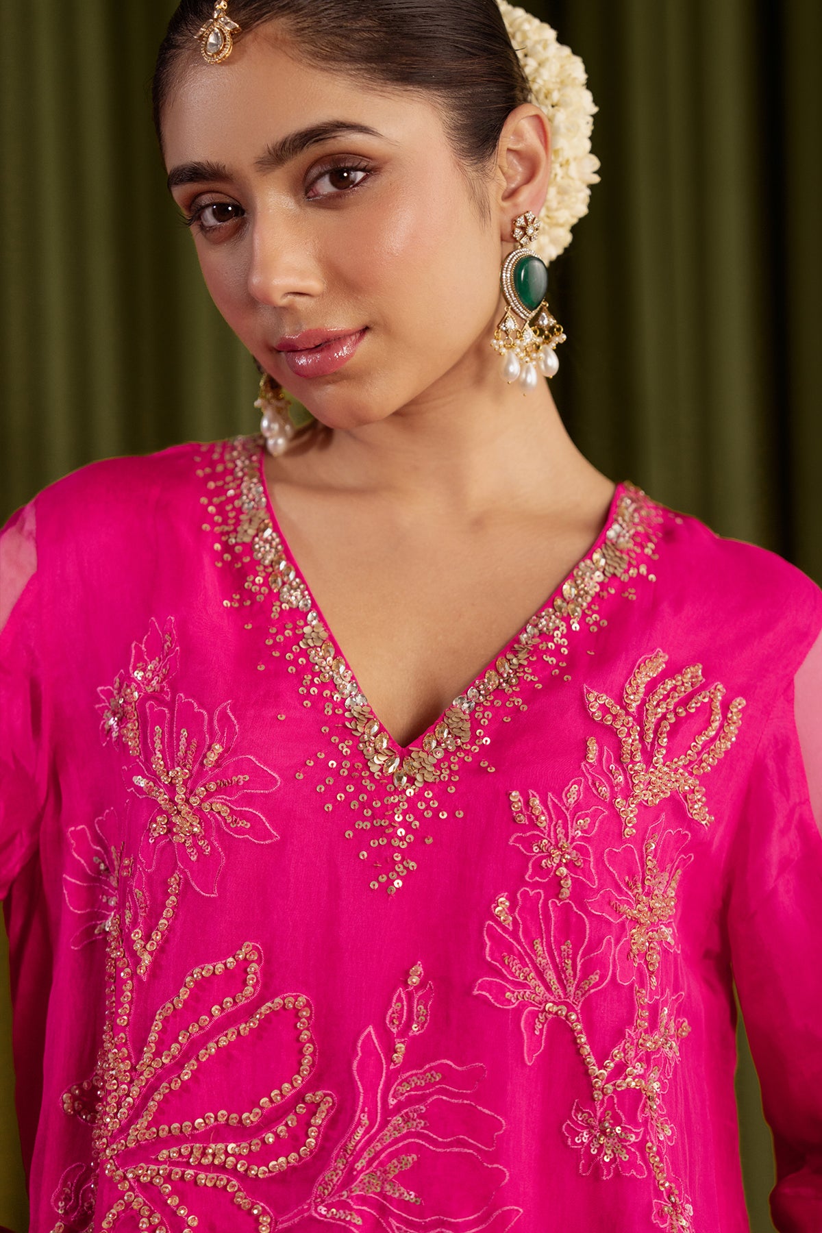 Hot pink sharara set with embroidered magnolia flower pattern.