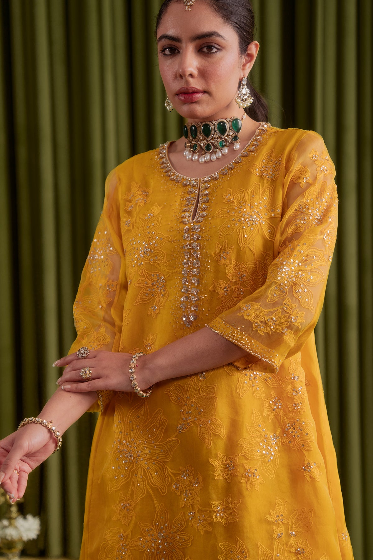 Golden yellow kalidar kurta set with delicate floral embroidery.
