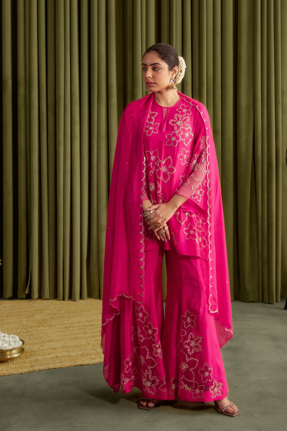 Hot pink sharara set with hand embroidered floral pattern.