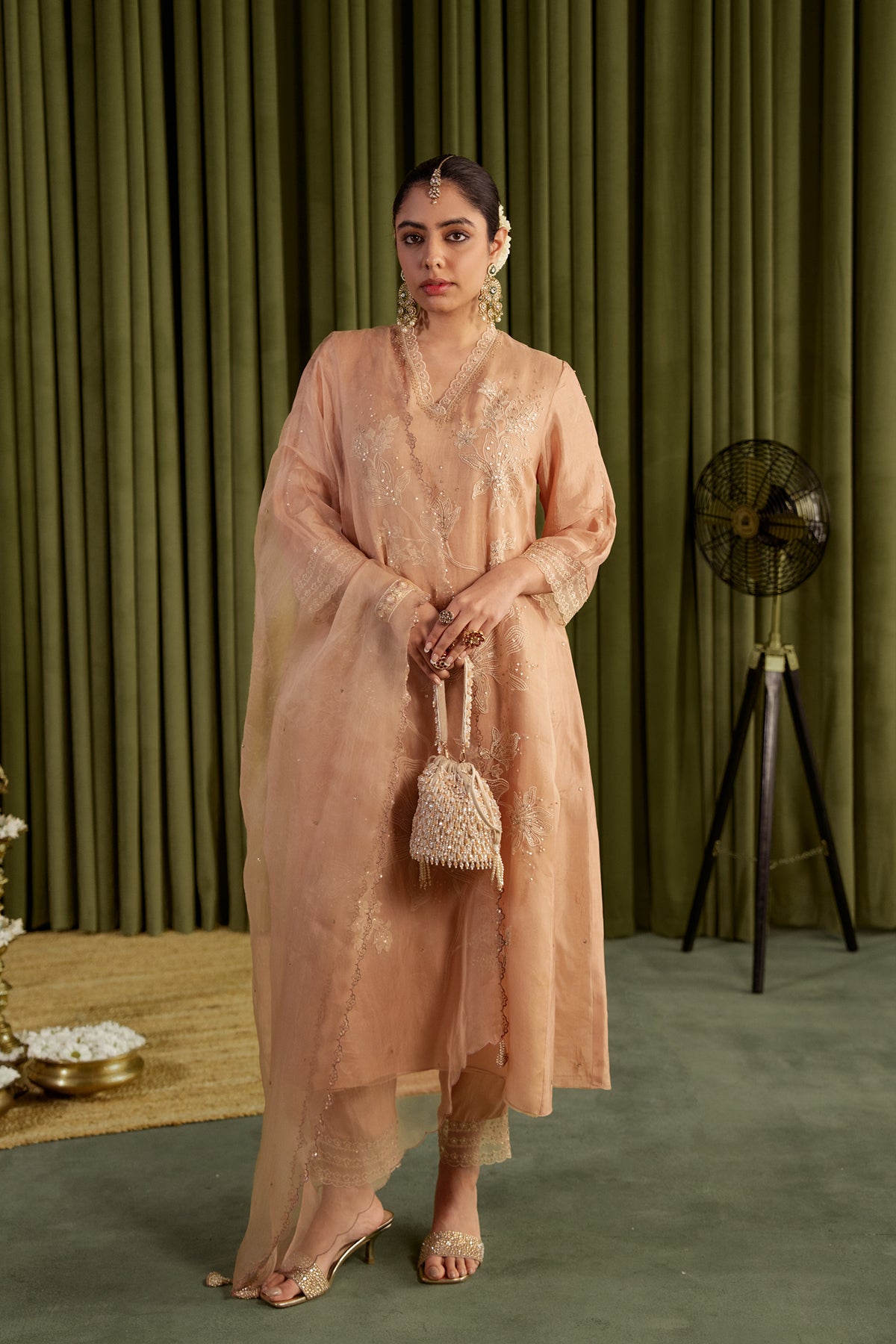Golden beige kurta set with delicate floral embroidery.